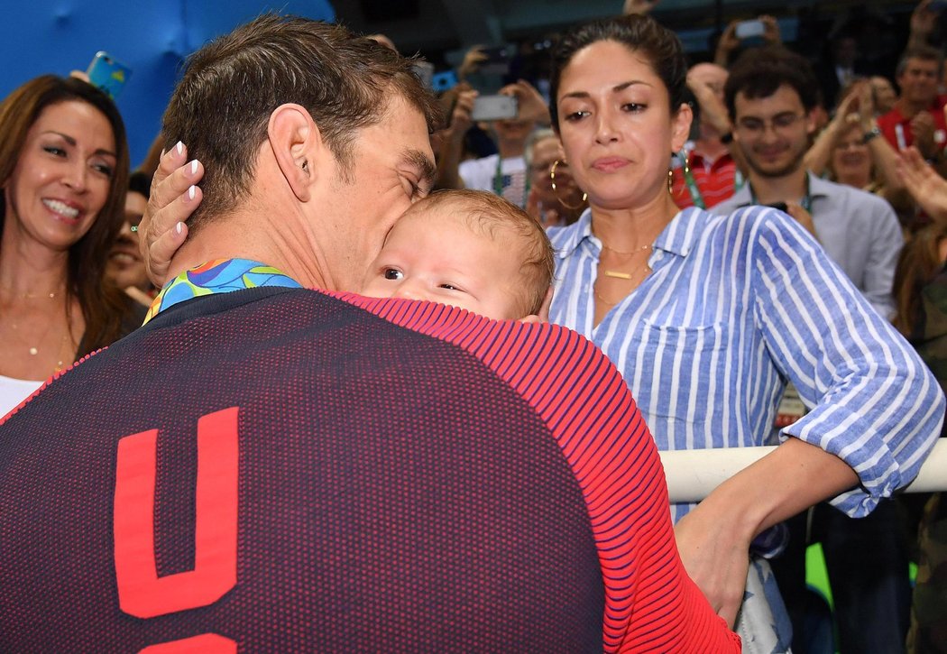 Michael Phelps chová svého syna Boomera po triumfu na 200 metrů motýlek