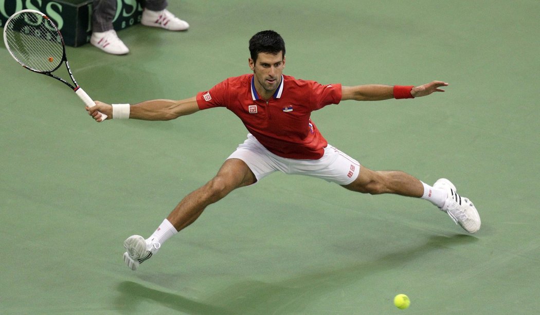 Djokovič odvrací míček při jedné z výměn ve finále Davis Cupu proti Tomáši Berdychovi