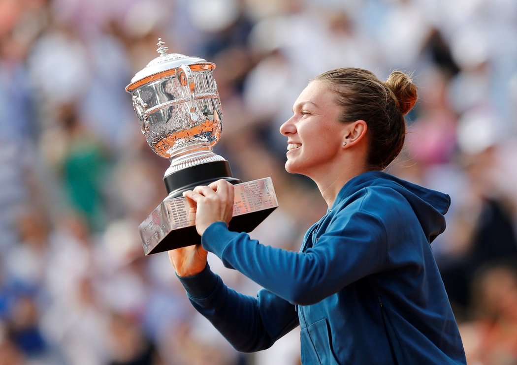 Simona Halepová zvedá vytoužený pohár z French Open, který získala až na třetí finálový pokus...