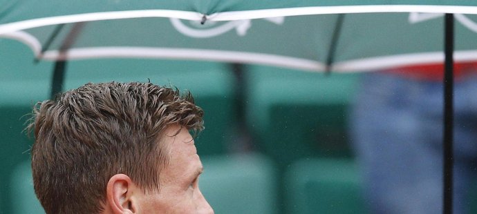 Tomáš Berdych pod deštníkem krátce poté, co rozehrál své pařížské osmifinále proti Davidu Ferrerovi