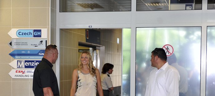 Přílet Petry Kvitové z Wimbledonu. U východu do letištní haly už čeká svalovec Ruda (vlevo)