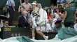 Andy Murray odchází z centrálního kurtu, když jeho zahajovací zápas Wimbledonu přerušil déšť