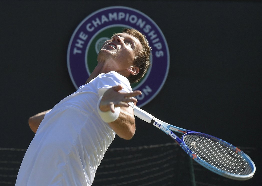 Tomáš Berdych podává ve čtvrtfinále Wimbledonu proti domácímu Lucasi Pouillemu