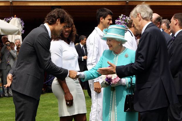 Královna Alžběta se zdraví s Rogerem Federerem. V pozadí přihlíží Serena Williamsová a Novak Djokovič Královna Alžběta se zdraví s Rogerem Federerem. V pozadí přihlíží Serena Williamsová a Novak Djokovič