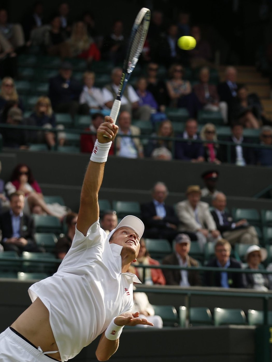 Tomáš Berdych podává v zápase prvního kola Wimbledonu proti Martinu Kližanovi ze Slovenska