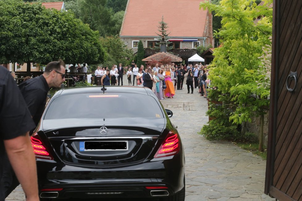 Novomanželé přijíždějí na hostinu luxusním mercedesem.