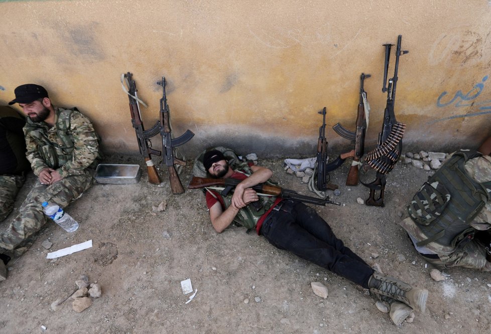 A Turkey, backed Syrian rebel fighter takes a rest near the border town of Tal Abyad