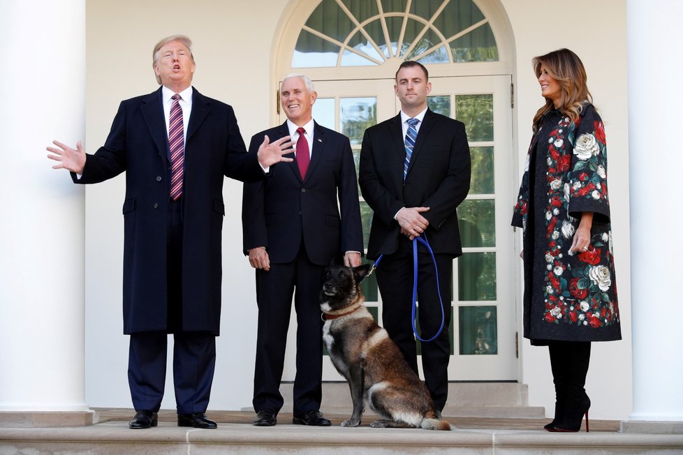 U.S. President Donald Trump speaks to the news media next to Vice President Mike Pence and Conan, the U.S. military dog that participated in and was injured in the U.S. raid in Syria that killed ISIS leader Abu Bakr al, Baghdadi
