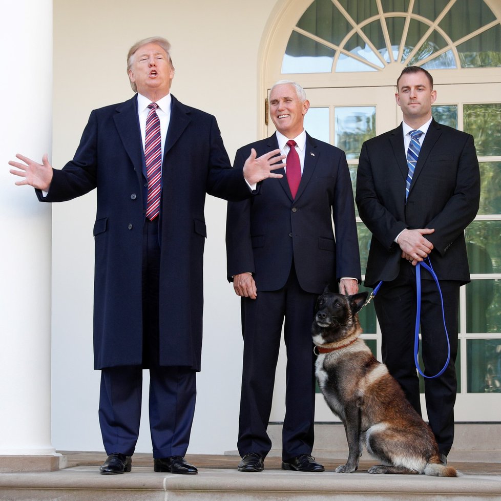 U.S. President Donald Trump speaks to the news media next to Vice President Mike Pence and Conan, the U.S. military dog that participated in and was injured in the U.S. raid in Syria that killed ISIS leader Abu Bakr al, Baghdadi