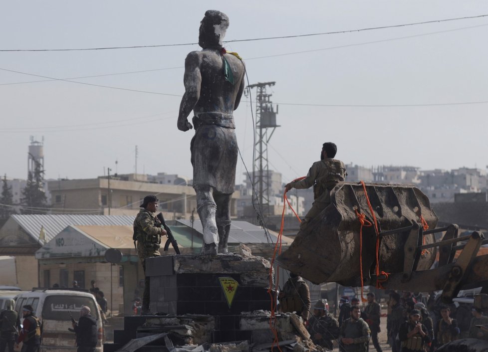Vojáci Svobodné syrské armády strhávají kurdskou sochu v centru Afrínu