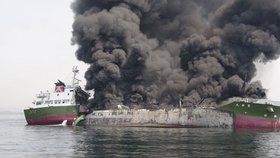 Tanker pohltily plameny a stoupal z něj hustý dým.