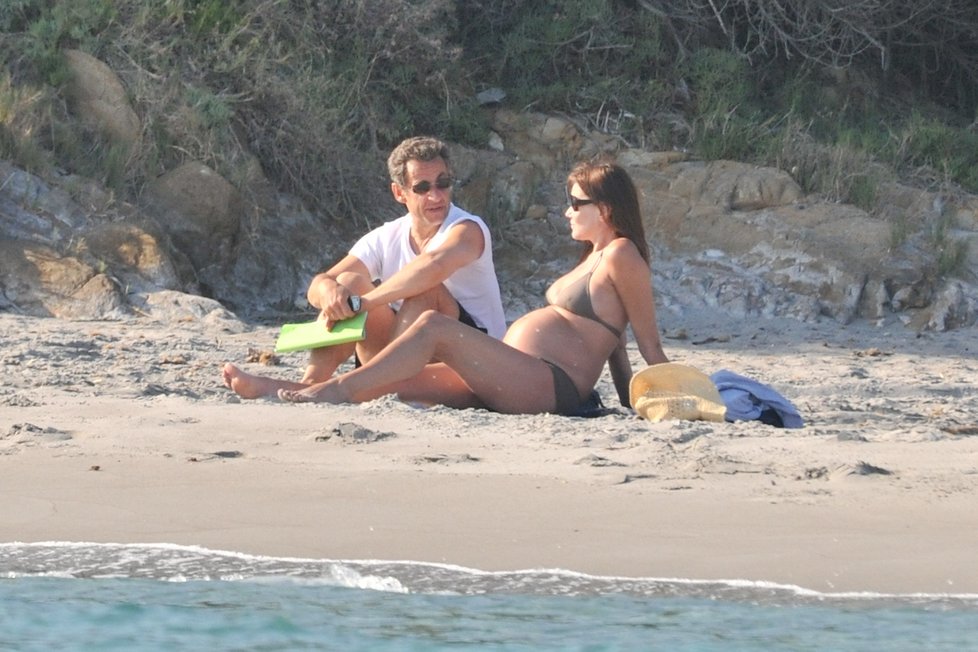 Těhotná Carla Bruni na pláži s manželem, bývalým francouzským prezidentem Sarkozym.