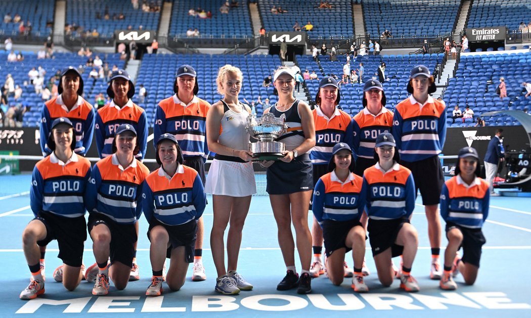 Kateřina Siniaková a Barbora Krejčíková se vyfotily s trofejí pro vítězky čtyřhry na Australian Open a sběrači míčků