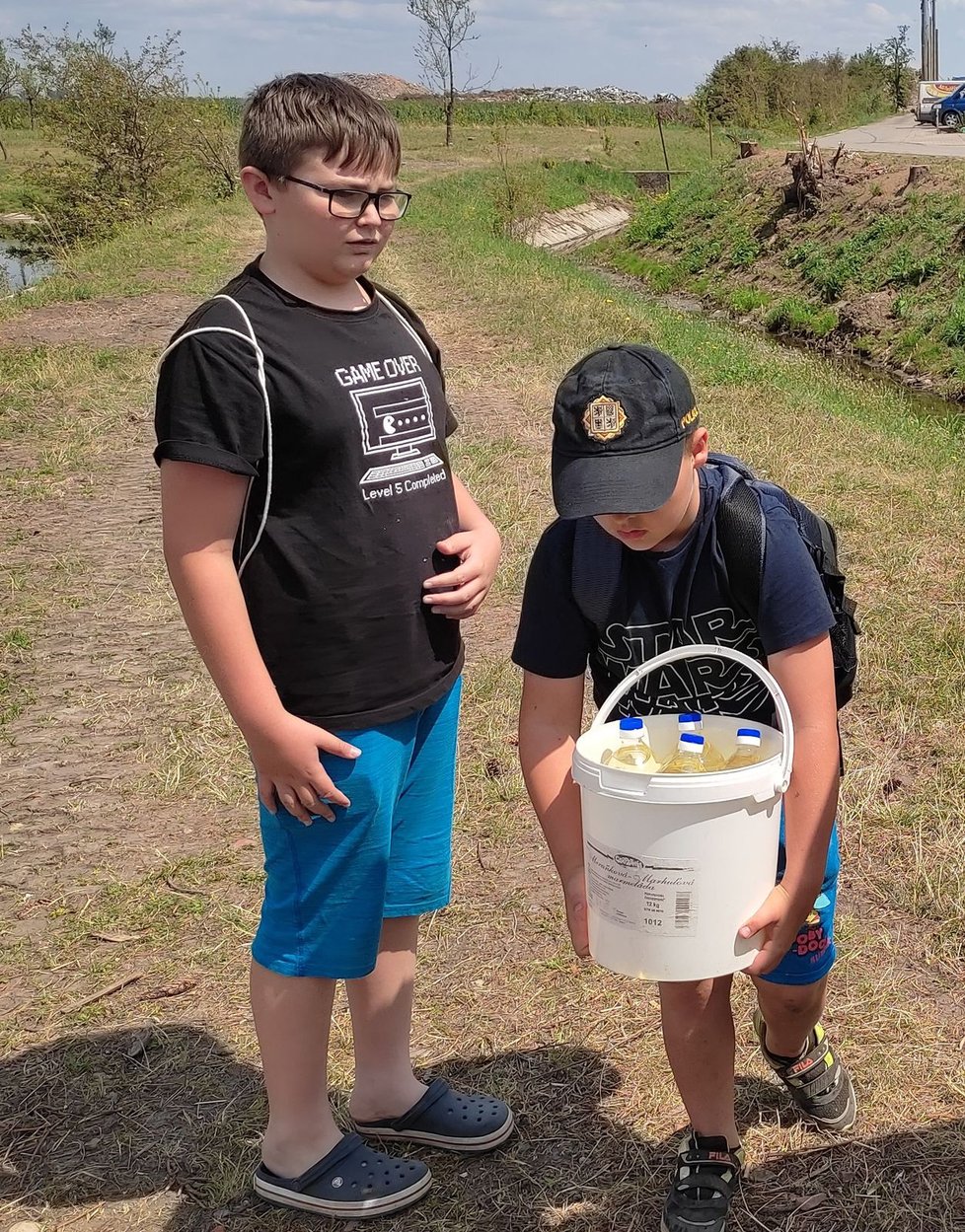 Jakub (8) odnáší zásoby do skladu, jeho kamarád Daniel (12) čeká na podobný náklad.