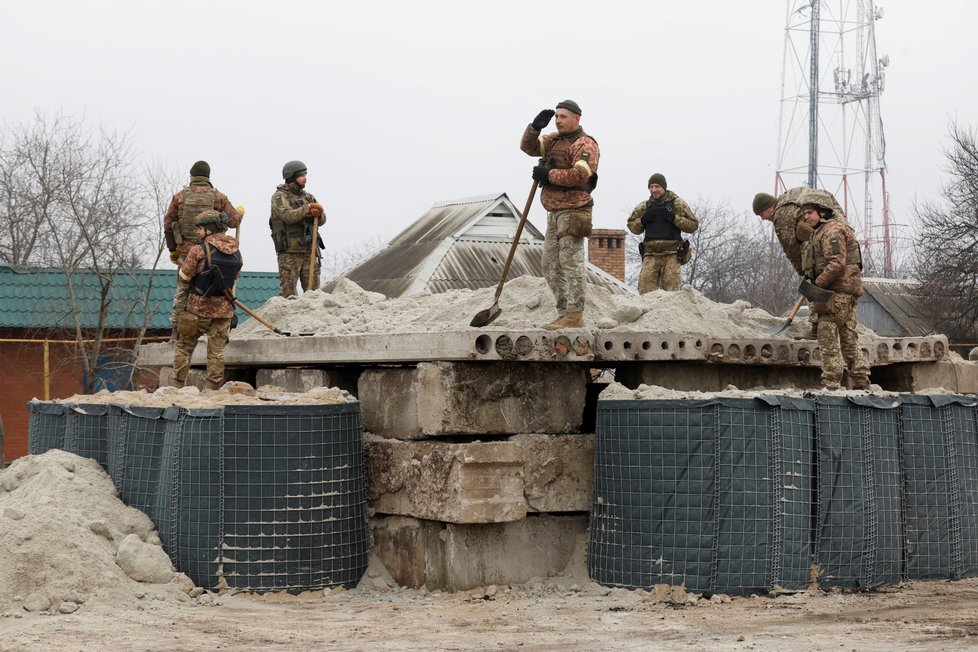 Ukrajinští vojáci budují improvizovaný bunkr z písku. (Bachmut, 26. 12. 2022).