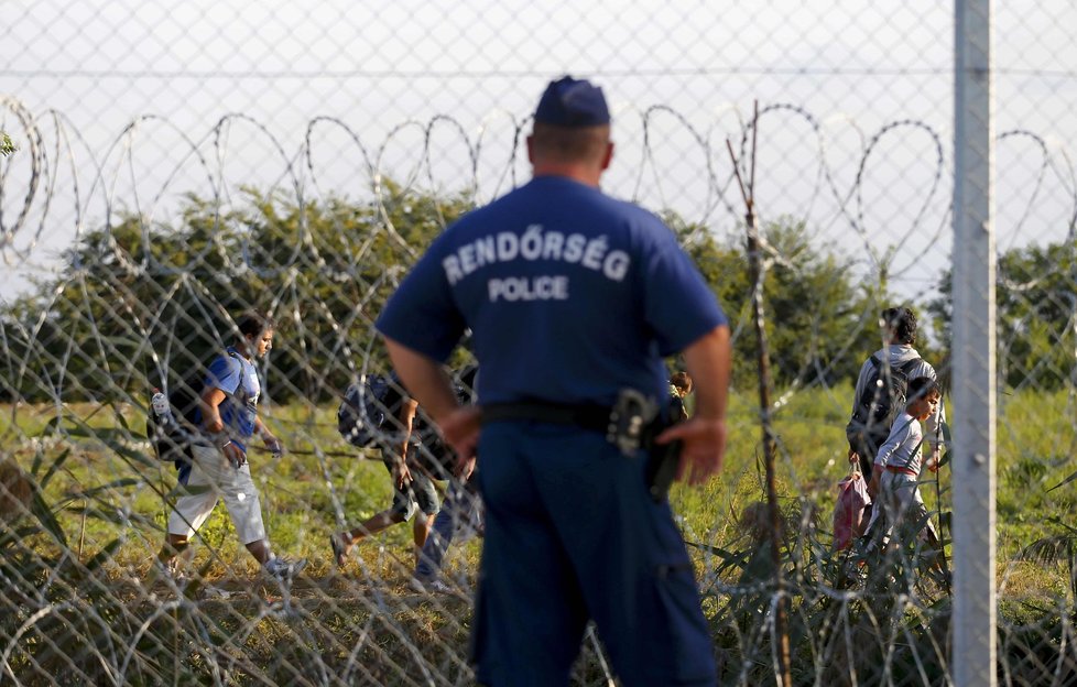 Maďarský strážník dohlíží na pohyb uprchlíků na srbsko-maďarské hranici.