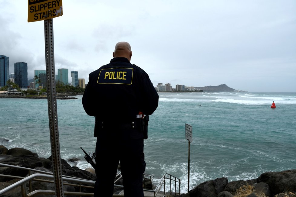 Policisté v Honolulu před příchodem hurikánu Lane bedlivě střeží hladinu vody a několik surfařů, kteří se stále odvažují na moře (23.8.2018).
