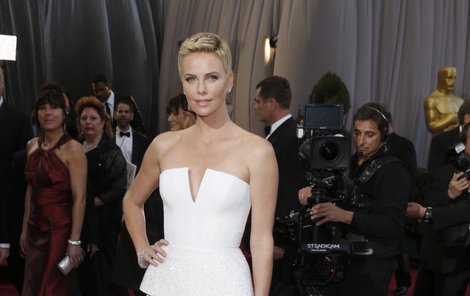 Charlize Theron na koberci, kde zachránila život muži.