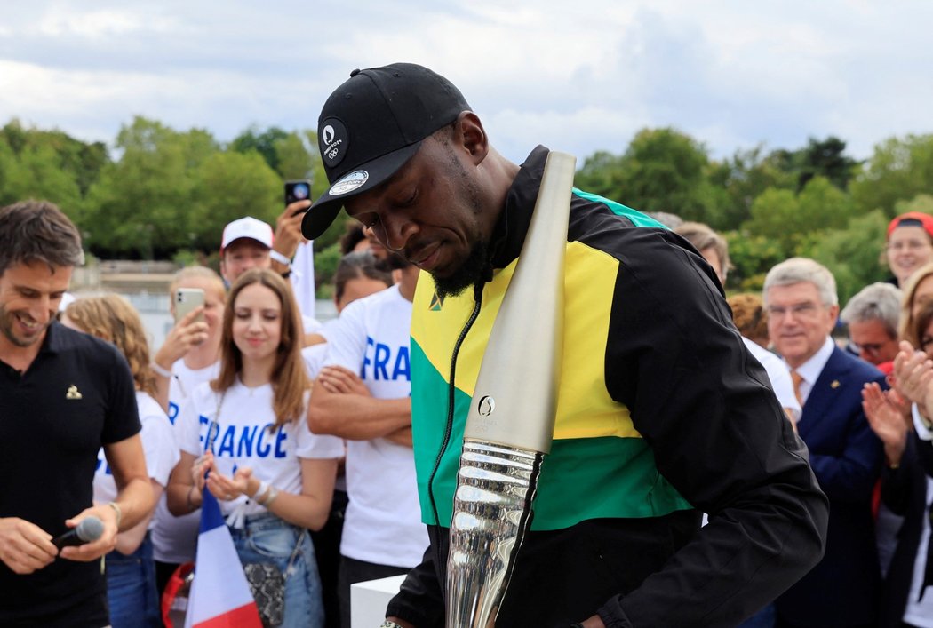 Usain Bolt s olympijskou pochodní