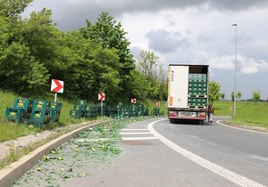 Na křížení ulic Kbelská a Veselská se z nákladního vozu vysypaly basy s lahvemi od piva. (19. květen 2021)