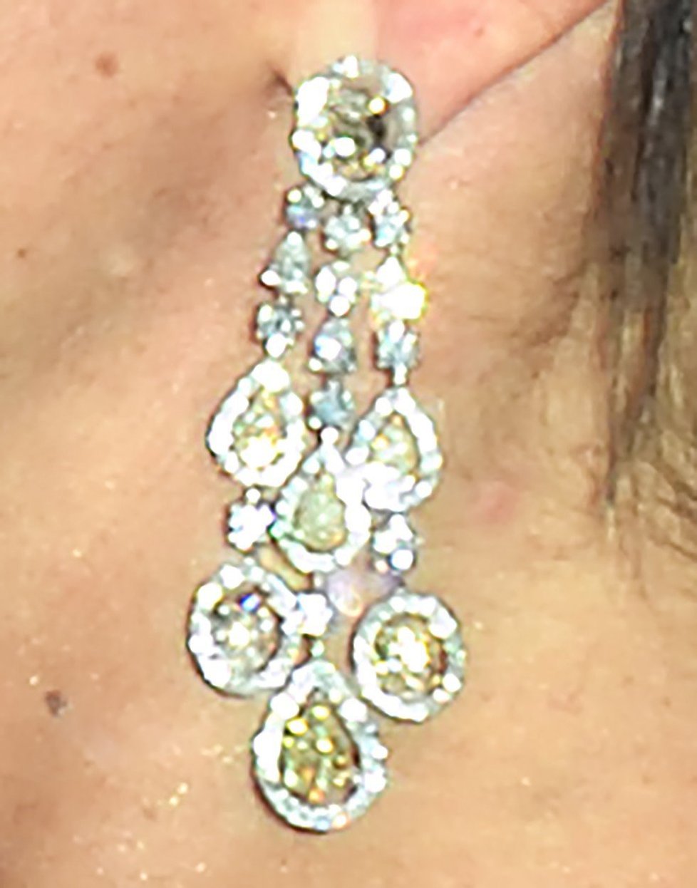 Vévodkyně Meghan s masivními visícími náušnicemi poseté diamanty.