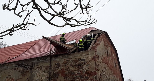 Hasiči 28. prosince 2020 v Jihlavě zajišťují plechovou střechu poškozenou silným větrem.