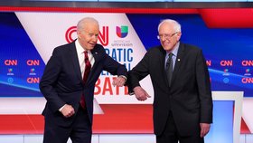 (Zleva) Viceprezident Joe Biden a senátor Bernie Sanders na debatě demokratických kandidátů na prezidenta si podali ruce loktem (16.  3. 2020)