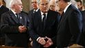 Komorowski and former Polish President Kwasniewski shake hands, as former President Walesa looks back during mass ceremony