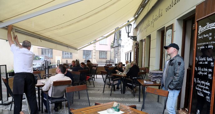 Lidé sedí na jedné z restauračních zahrádek v Praze, které se 17. května 2021 mohly otevřít po uvolnění protikoronavirových opatření..