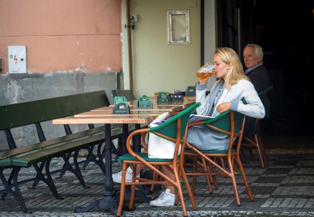 Zákaznice pije pivo na jedné z restauračních zahrádek v centru Prahy, které se mohly otevřít po uvolnění protikoronavirových opatření (17. 5. 2021)