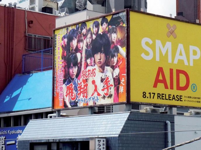 Zatímco populární hudební
skupina SMAP inzeruje
charitativní CD, dívčí
seskupení AKB48, idol
mladých Japonců, představuje
kýčovitou reklamní klasiku