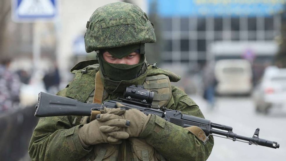 Voják s útočnou puškou AK-47. Je na ní uchycena je laserový zaměřovací dalekohled