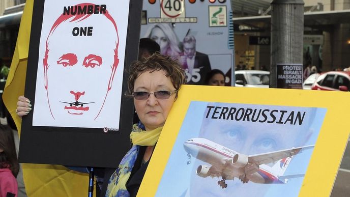 Žena drží protiruské plakáty kvůli sestřelení malajsijského letadla při protestu v australském Sydney